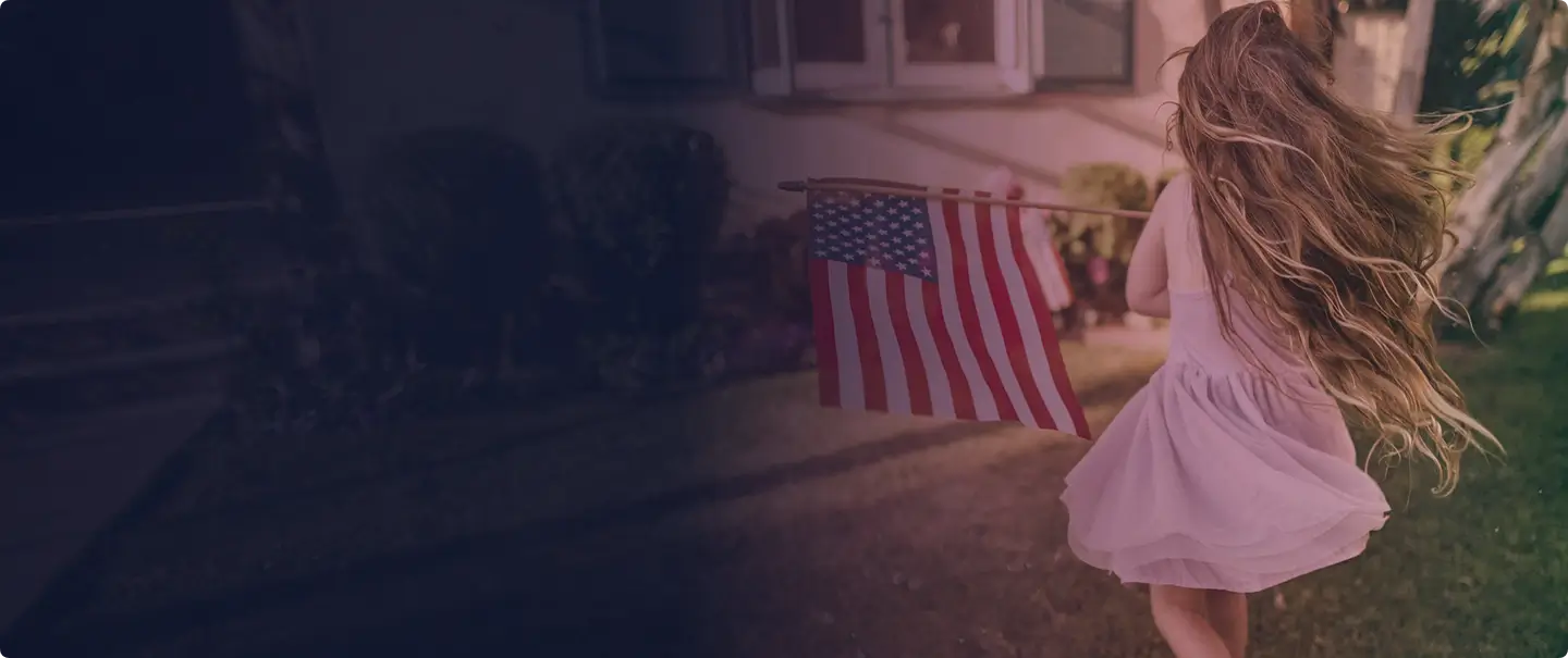 Child carrying an American flag